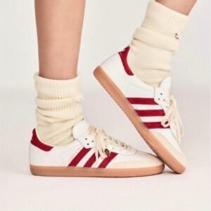 White and green/red Sporty & Rich retro sneakers with gum sole and vintage design.